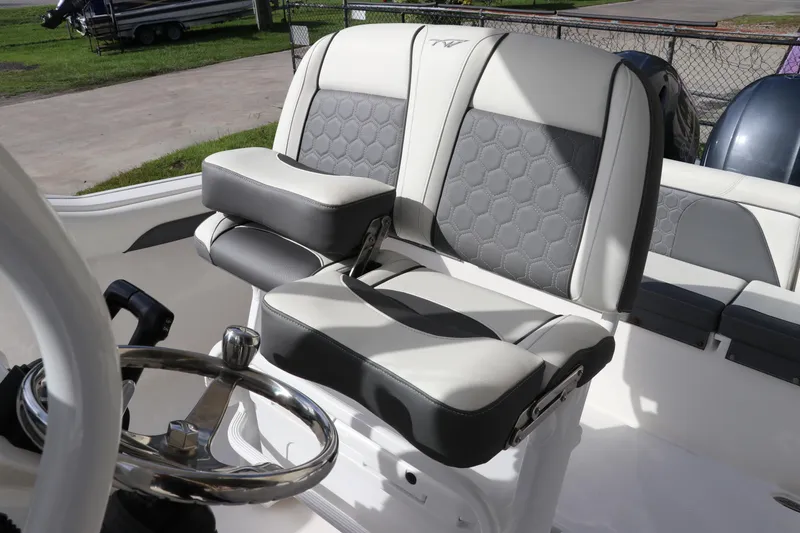 Slide: The Image of 2020 Tidewater 252 LXF boat interior with stylish seating and steering wheel. - 20