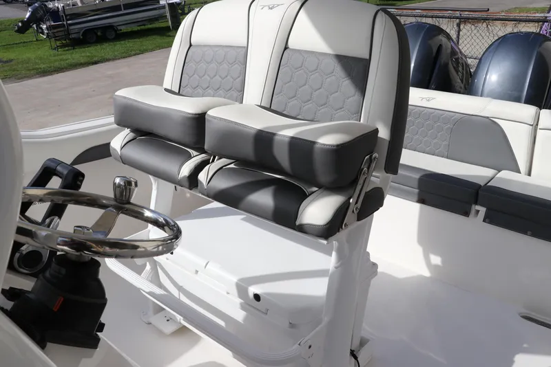Slide: The Image of 2020 Tidewater 252 LXF boat interior with dual seats and steering wheel. - 21