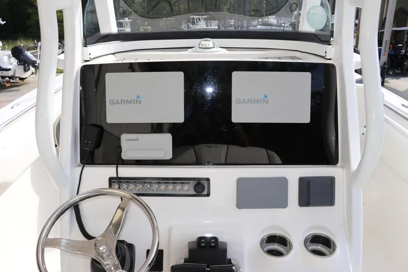 Slide: The Image of 2020 Tidewater 252 LXF boat dashboard with Garmin navigation system and steering wheel. - 22