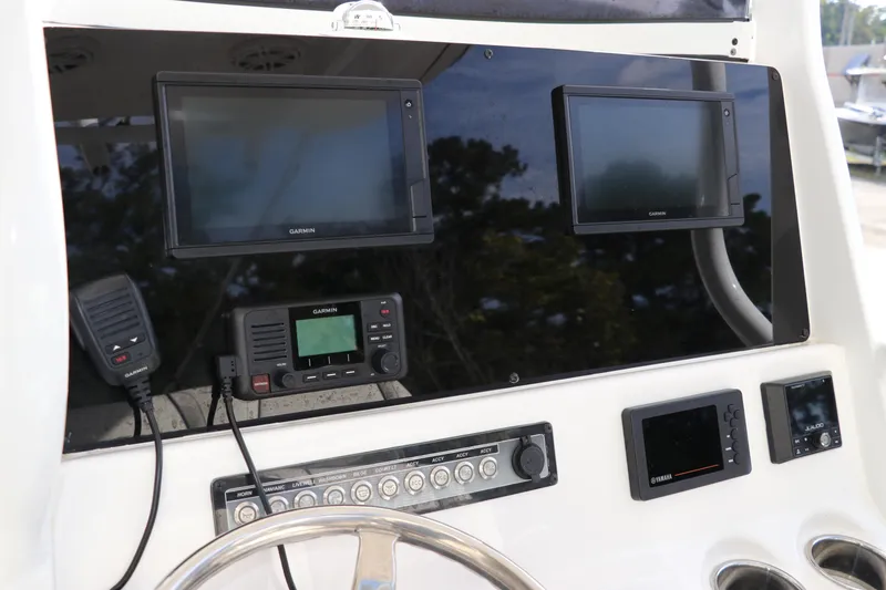 Slide: The Image of 2020 Tidewater 252 LXF dashboard with Garmin displays and Yamaha controls. - 24