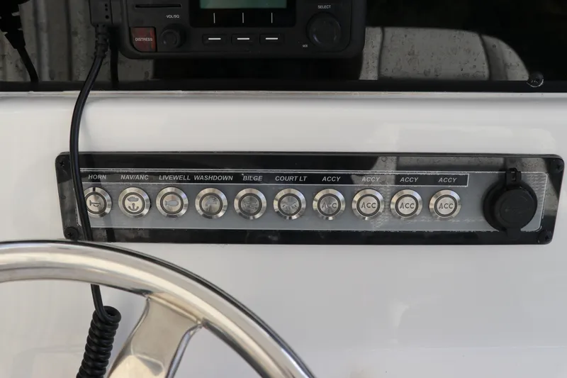 Slide: The Image of Control panel of 2020 Tidewater 252 LXF boat with labeled switches and steering wheel. - 25