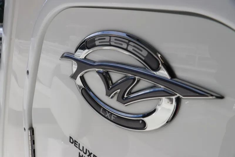Slide: The Image of 2020 Tidewater 252 LXF logo on boat exterior, featuring sleek chrome design. - 33