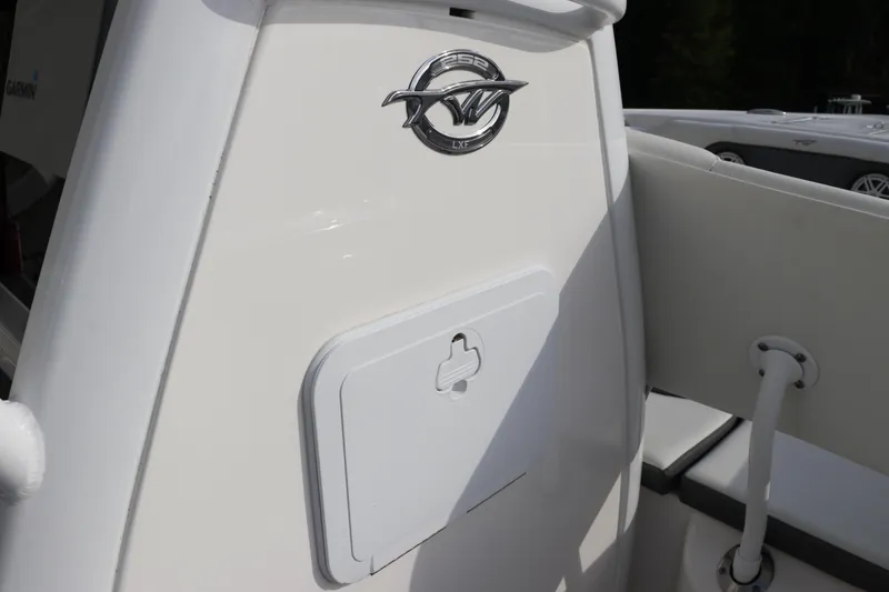 Slide: The Image of 2020 Tidewater 252 LXF boat interior with logo and storage compartment. - 34