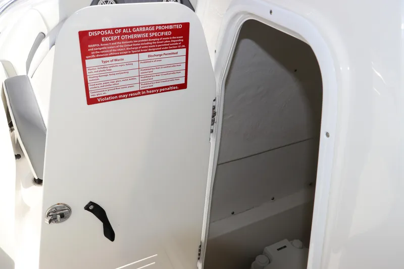 Slide: The Image of 2020 Tidewater 252 LXF boat cabin with waste disposal warning sign. - 37