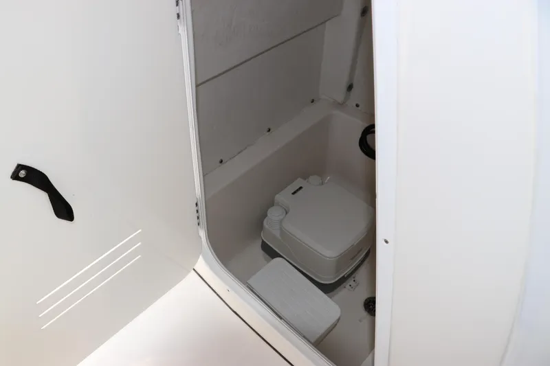 Slide: The Image of 2020 Tidewater 252 LXF boat interior with compact marine toilet. - 38