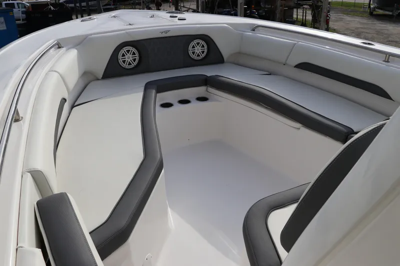Slide: The Image of 2020 Tidewater 252 LXF boat interior with cushioned seating and built-in speakers. - 41