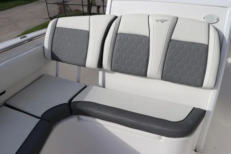Slide: The Image of 2020 Tidewater 252 LXF boat seating with gray and white upholstery, hexagonal pattern design. - 44