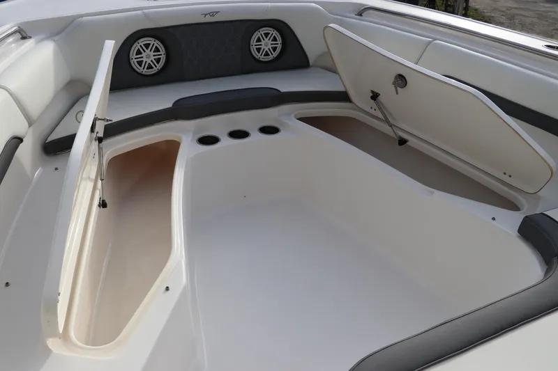 Slide: The Image of 2020 Tidewater 252 LXF boat interior with open storage compartments and speakers. - 47