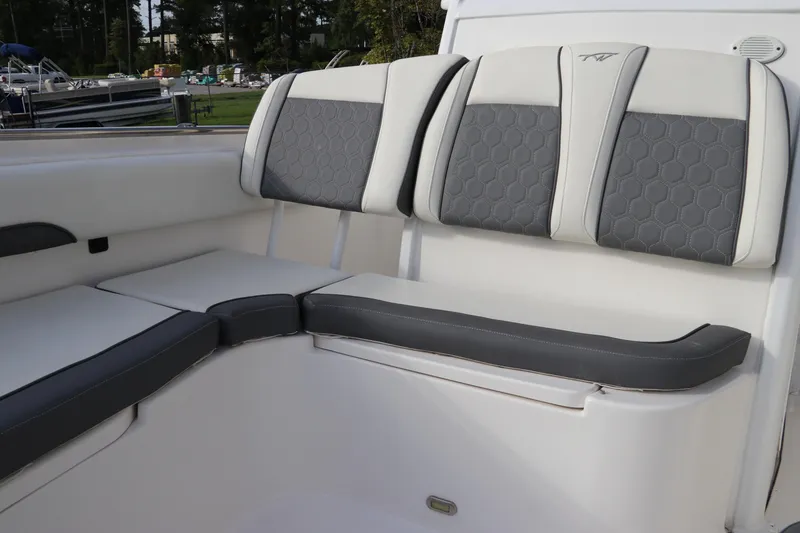 Slide: The Image of 2020 Tidewater 252 LXF boat interior seating with gray and white upholstery. - 51