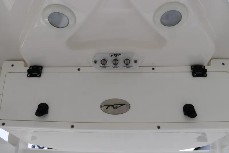 Slide: The Image of 2020 Tidewater 252 LXF boat control panel with switches and logo. - 59