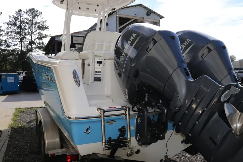 Slide: The Image of 2020 Tidewater 252 LXF boat with dual Yamaha engines on a trailer. - 8