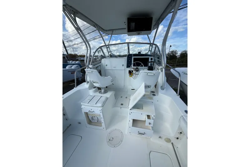 Slide: The Image of 2005 Polar 2300 Walkaround boat interior with helm, seating, and storage compartments. - 11