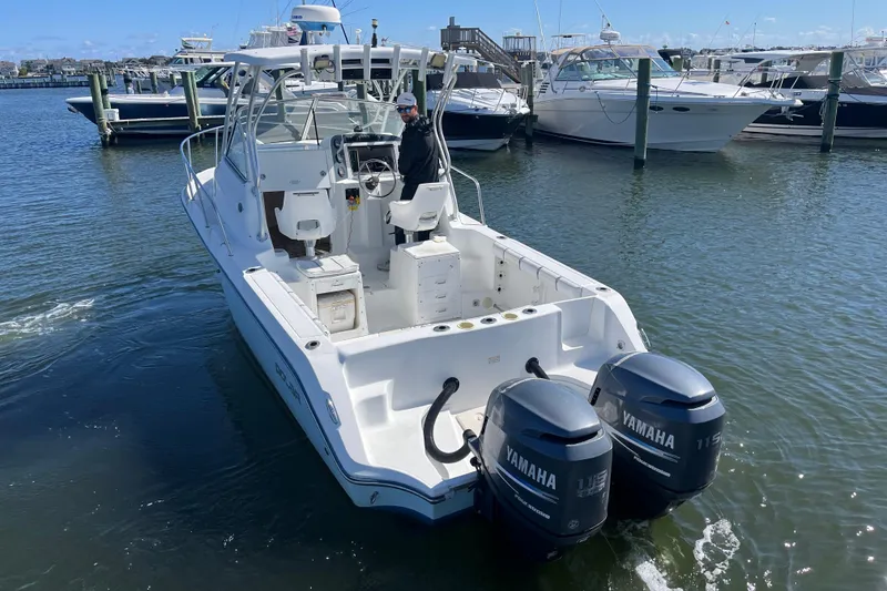 Slide: The Image of 2005 Polar 2300 Walkaround boat with twin Yamaha engines in a marina. - 2
