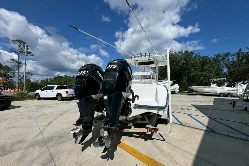 Slide: The Image of 2007 Venture 34 Open boat with dual Mercury 275 engines in a parking lot. - 13