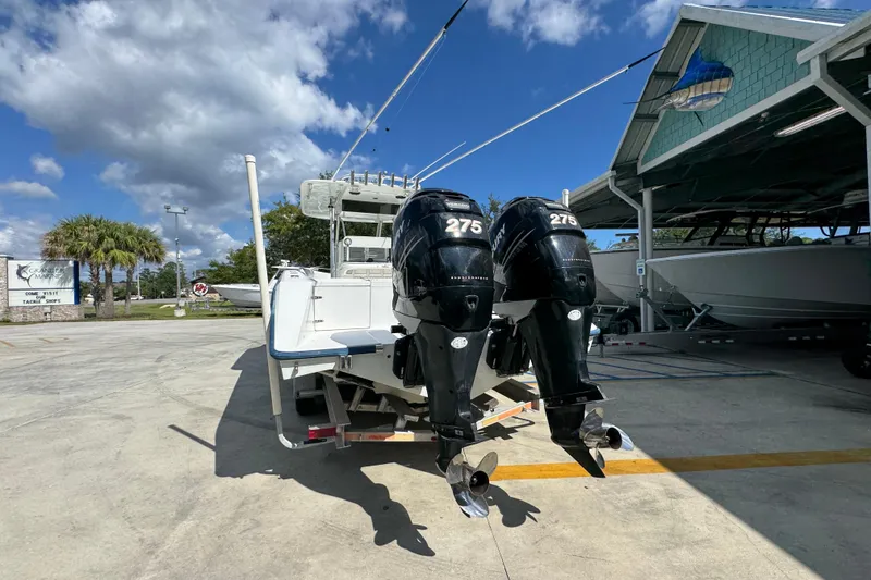 Slide: The Image of 2007 Venture 34 Open boat with twin 275 horsepower engines, parked outdoors under a blue sky. - 15