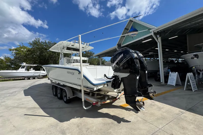 Slide: The Image of 2007 Venture 34 Open boat with dual Mercury engines on a trailer. - 16