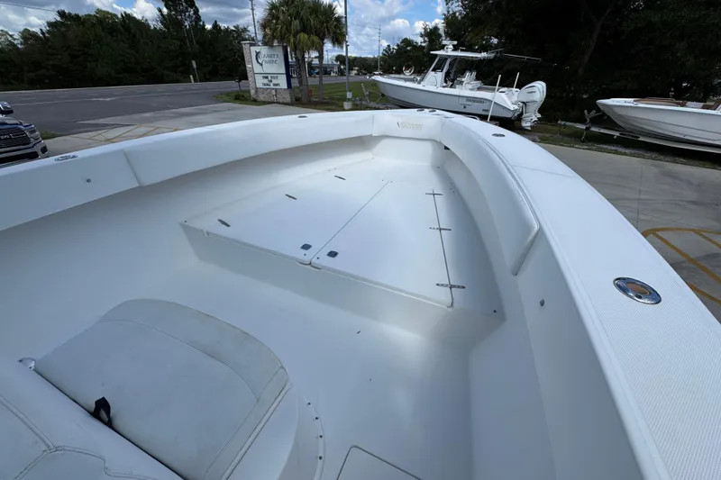 Slide: The Image of 2007 Venture 34 Open boat interior with seating and storage, parked outdoors. - 18