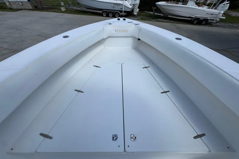 Slide: The Image of 2007 Venture 34 Open boat deck, spacious and clean, with storage compartments. - 19