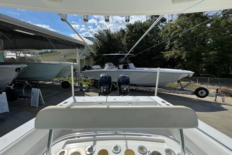 Slide: The Image of 2007 Venture 34 Open boat on trailer, parked outdoors under a clear sky. - 29