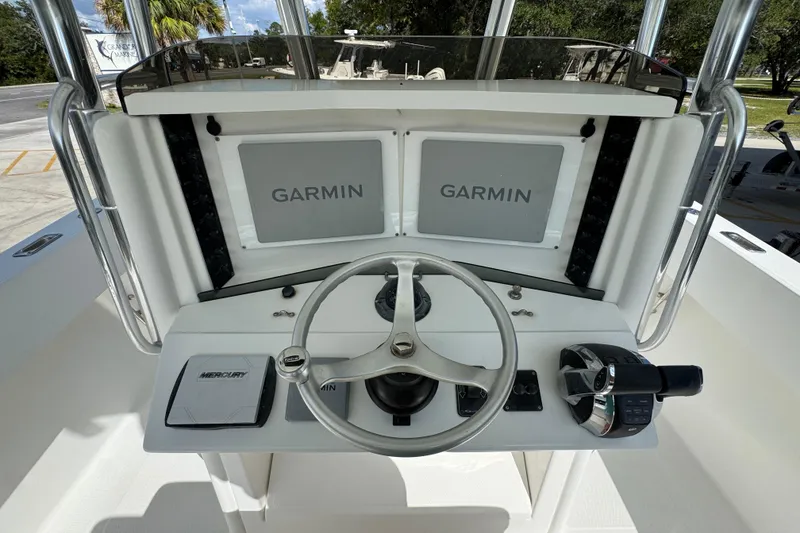 Slide: The Image of 2007 Venture 34 Open boat helm with dual Garmin displays and Mercury controls. - 31