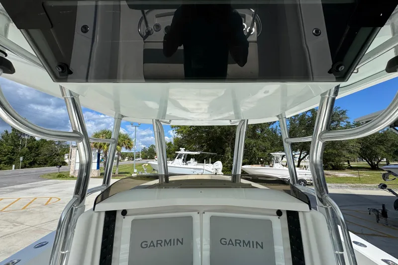 Slide: The Image of 2007 Venture 34 Open boat with Garmin electronics, docked outdoors under a clear sky. - 32