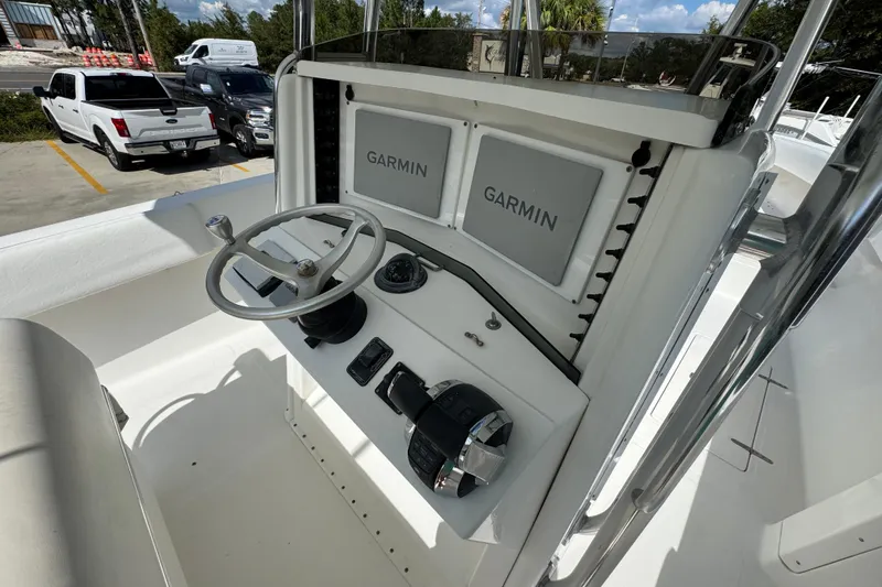 Slide: The Image of 2007 Venture 34 Open boat helm with Garmin displays and steering wheel. - 33