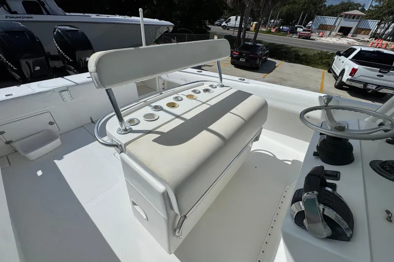 Slide: The Image of 2007 Venture 34 Open boat helm with seating and steering wheel in a parking lot setting. - 34