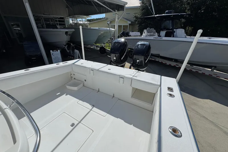 Slide: The Image of 2007 Venture 34 Open boat with dual Mercury engines in a marina setting. - 36