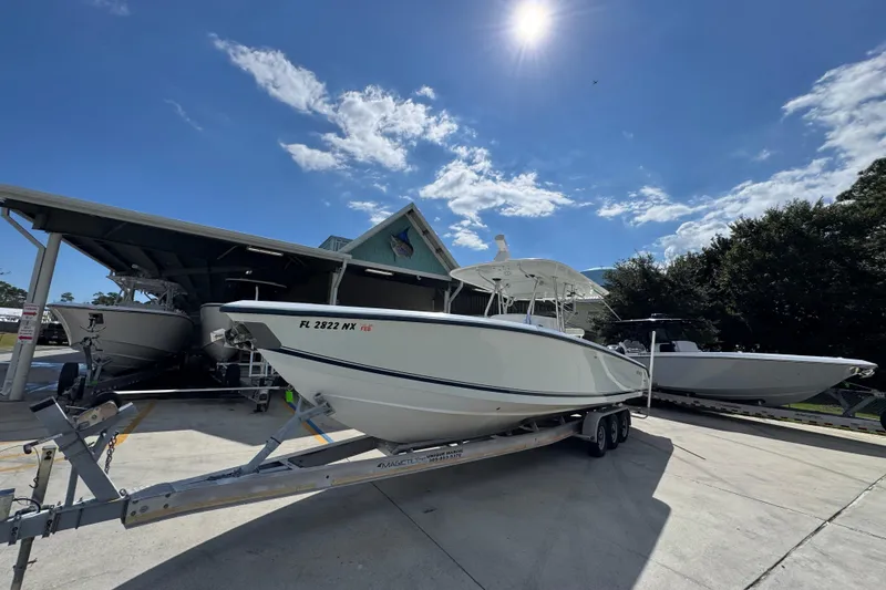 Slide: The Image of 2007 Venture 34 Open boat on trailer under sunny sky. - 4