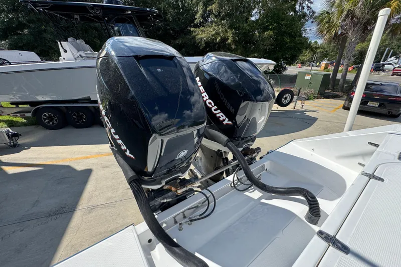 Slide: The Image of Twin Mercury outboard engines on a 2007 Venture 34 Open boat, parked outdoors. - 40