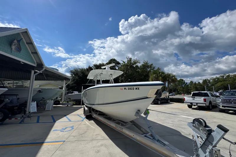 Slide: The Image of 2007 Venture 34 Open boat on trailer under a partly cloudy sky. - 7