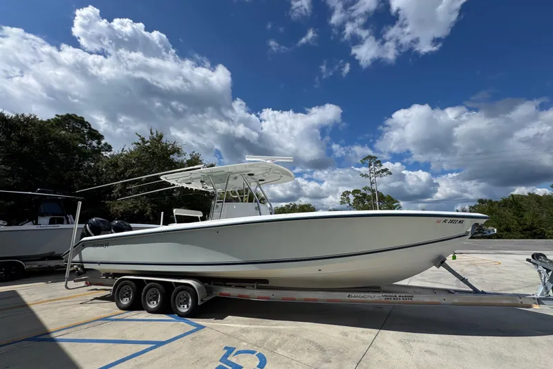 Slide: The Image of 2007 Venture 34 Open boat on trailer under a partly cloudy sky. - 9