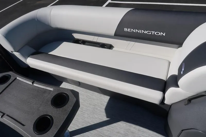 Slide: The Image of Storage compartment on 2026 Bennington S Swingback 22 SSB boat, featuring sleek design and cup holders. - 17
