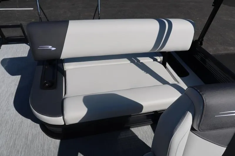 Slide: The Image of 2026 Bennington S Swingback 22 SSB pontoon boat interior with seating and helm in parking lot. - 6