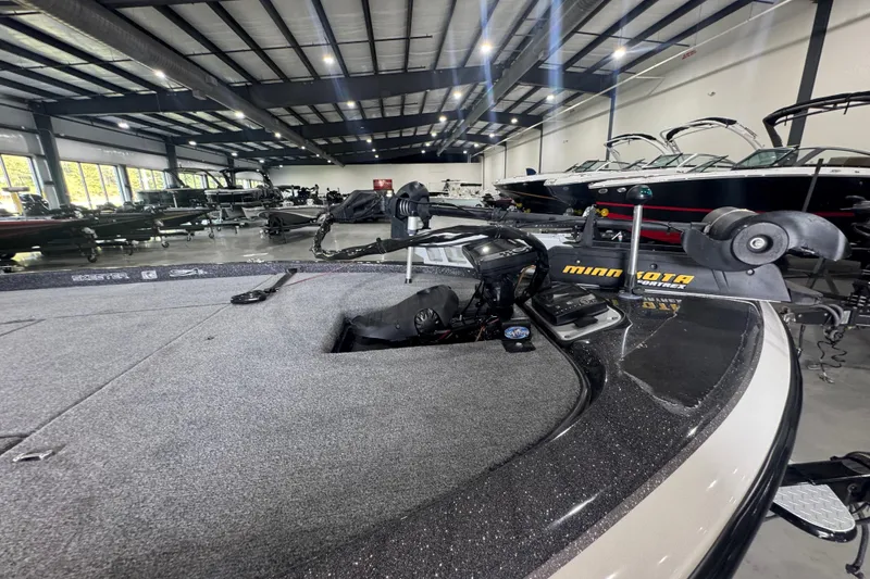 Slide: The Image of 2011 Skeeter ZX225 boat in showroom, featuring Minn Kota trolling motor. - 12