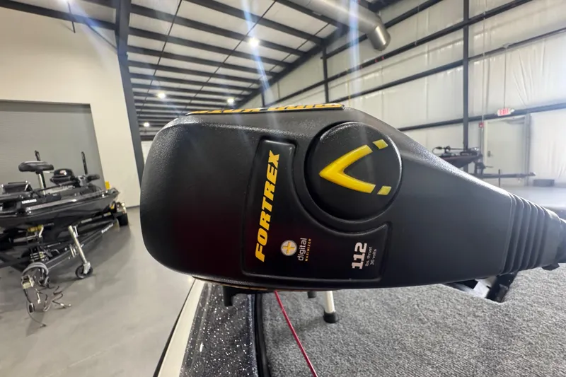 Slide: The Image of Close-up of a Fortrex trolling motor on a 2011 Skeeter ZX225 boat in a warehouse. - 14