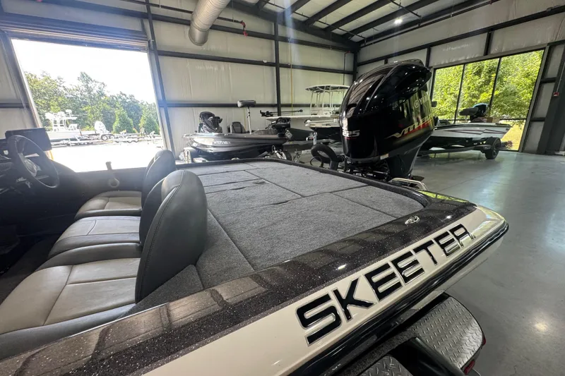 Slide: The Image of 2011 Skeeter ZX225 boat in showroom, featuring spacious seating and powerful engine. - 17