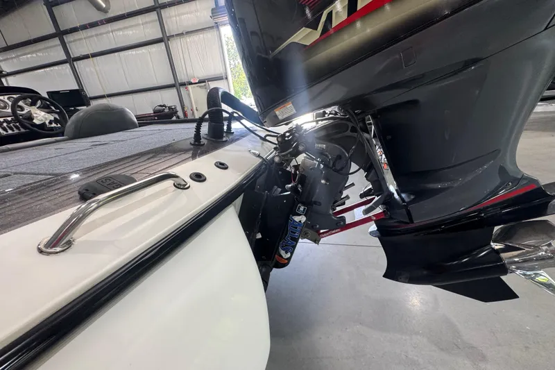 Slide: The Image of 2011 Skeeter ZX225 boat engine and deck in a garage setting. - 18