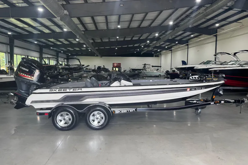 Slide: The Image of 2011 Skeeter ZX225 boat with Yamaha engine in a showroom. - 2