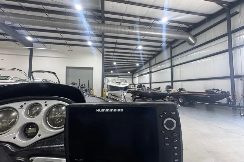 Slide: The Image of 2011 Skeeter ZX225 boat in a spacious indoor storage facility with Humminbird Helix 9 display. - 6