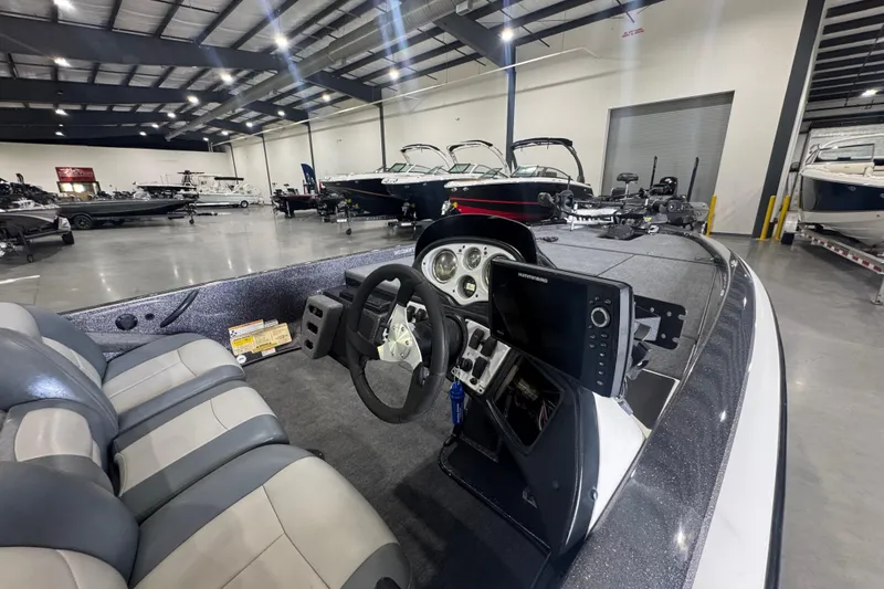Slide: The Image of 2011 Skeeter ZX225 boat interior with steering wheel and navigation system in showroom. - 7