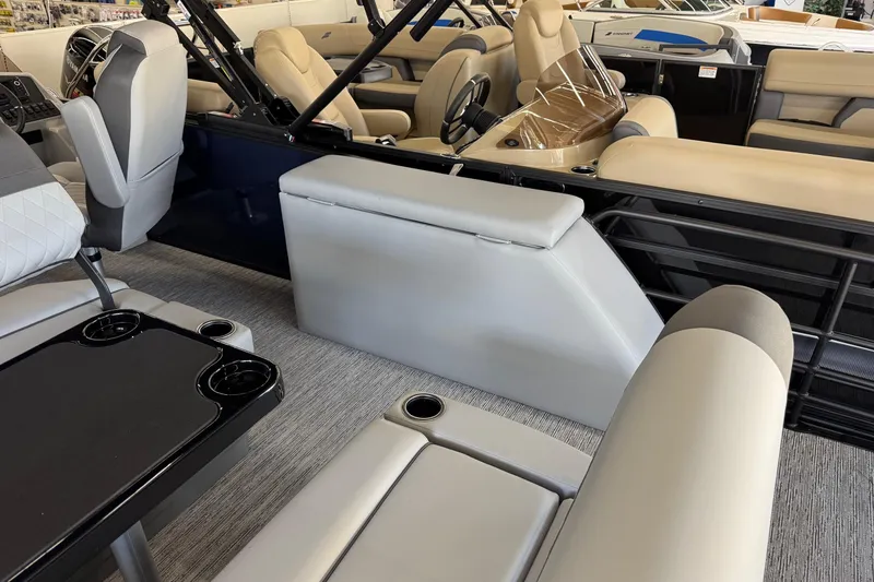 Slide: The Image of Interior of 2026 Starcraft EXS 3 boat with beige seating and black table. - 15