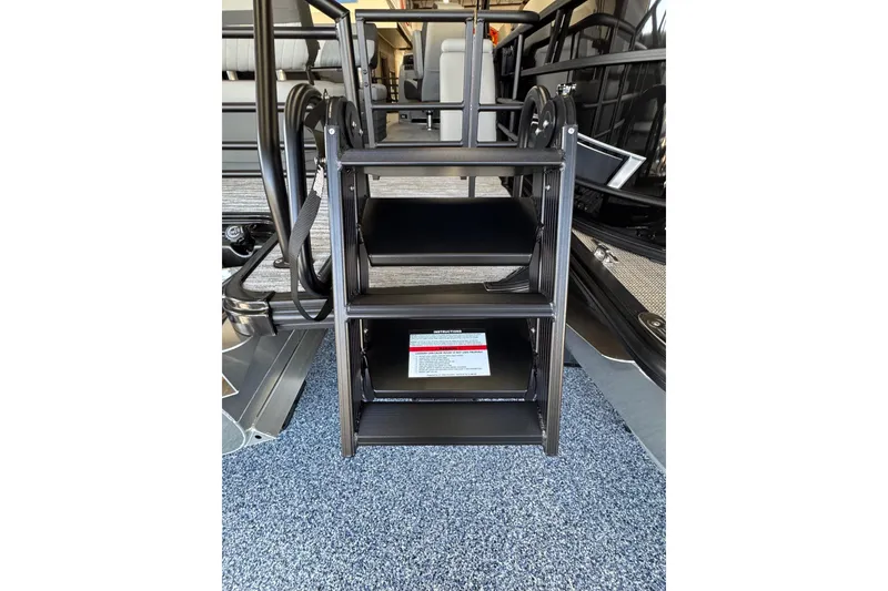 Slide: The Image of Starcraft EXS 3 2026 boat interior with foldable metal steps and carpeted flooring. - 18