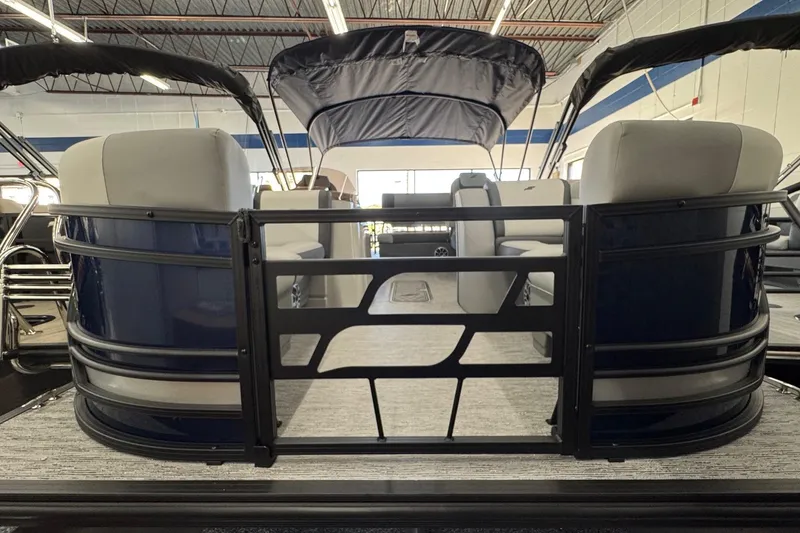 Slide: The Image of 2026 Starcraft EXS 3 pontoon boat interior with seating and canopy in showroom. - 2