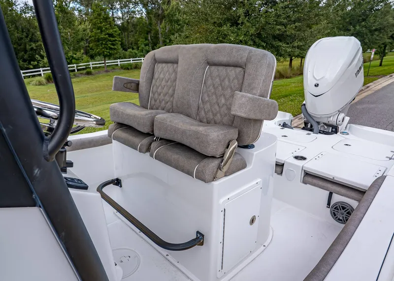 Slide: The Image of 2026 Sea Hunt BX 25 FS boat interior with cushioned seating and modern outboard motor. - 16