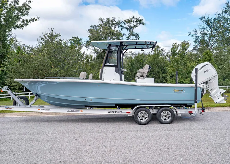 Slide: The Image of 2026 Sea Hunt BX 25 FS boat on trailer, side view, outdoors. - 2