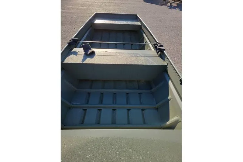 Slide: The Image of 2024 Polar Kraft 1648 Jon Boat interior, showing seating and floor details. - 6