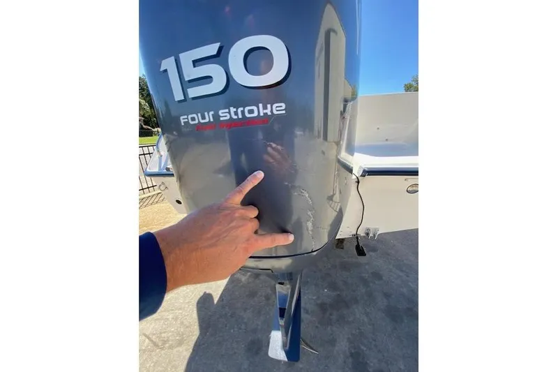 Slide: The Image of Outboard motor of a 2004 Sea Hunt Triton 220, showing "150 four stroke" label. - 10