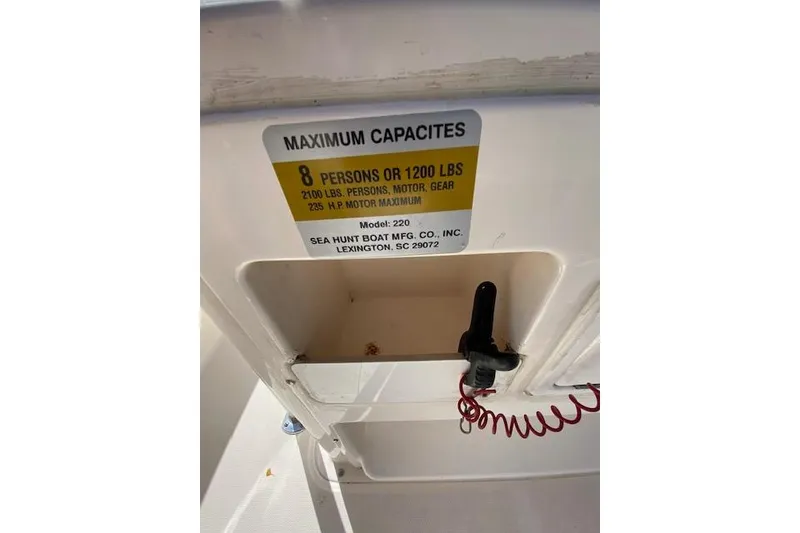 Slide: The Image of Sea Hunt Triton 220 boat capacity label, 8 persons or 1200 lbs, 235 HP motor maximum. - 12