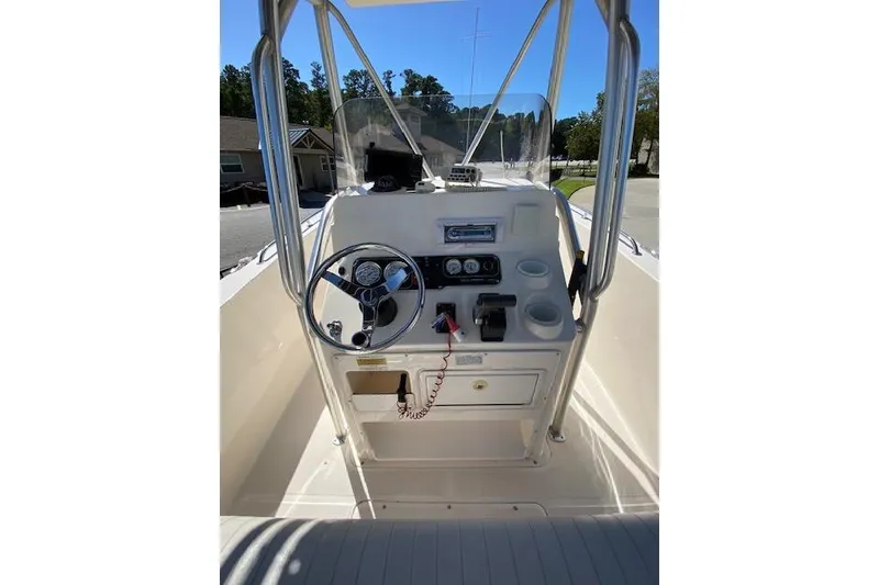 Slide: The Image of 2004 Sea Hunt Triton 220 boat console with steering wheel and controls. - 6